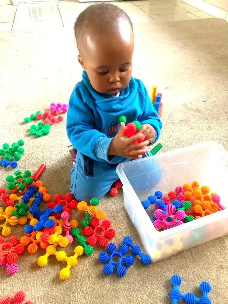 Babies playing with blocks in the baby room