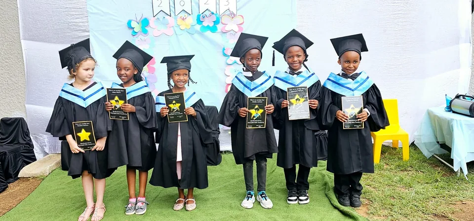 Waterfall Kids Academy Grade R graduates in caps and gowns holding their certificates