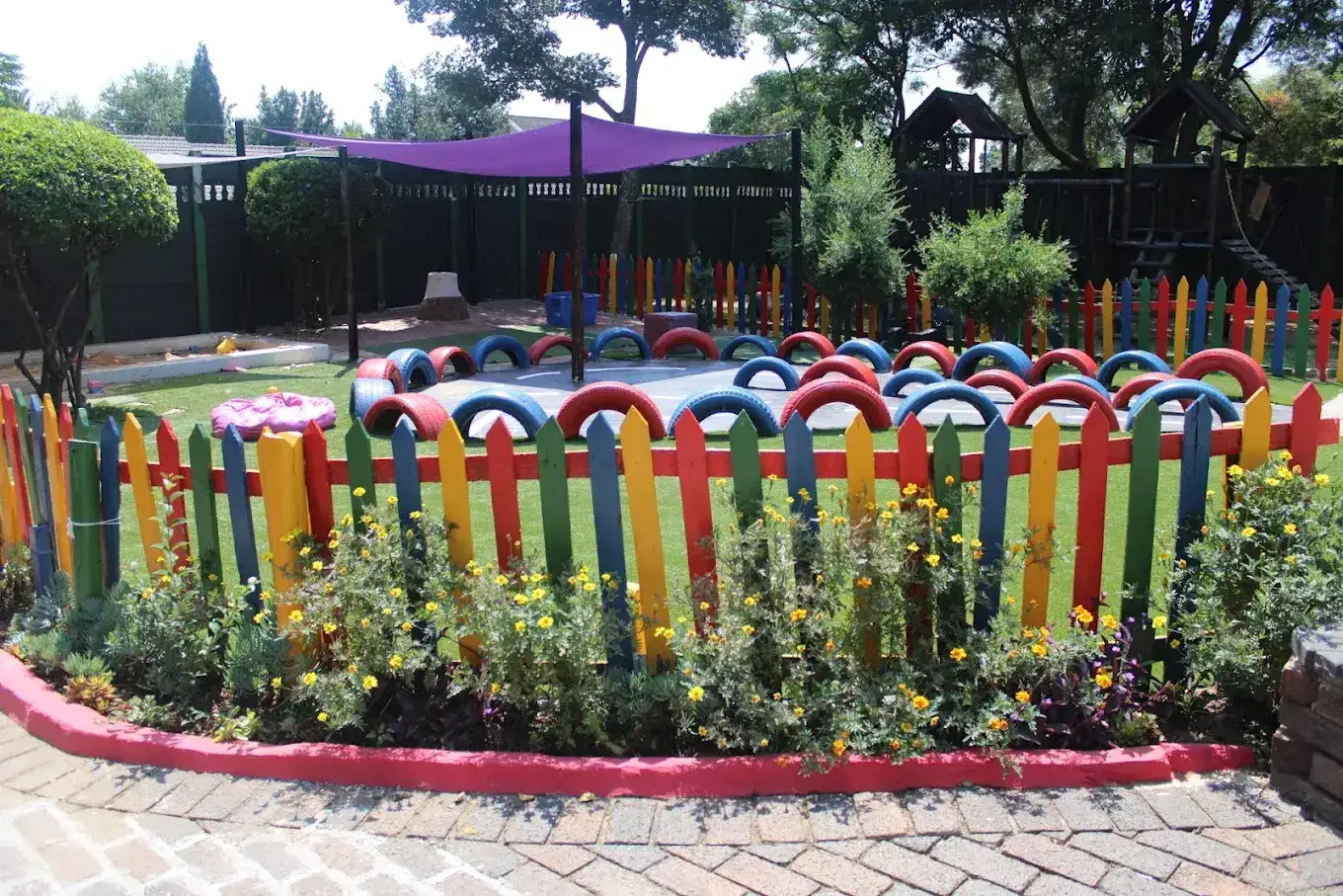 The colourful, leafy playground garden at Waterfall Kids Academy in Noordwyk